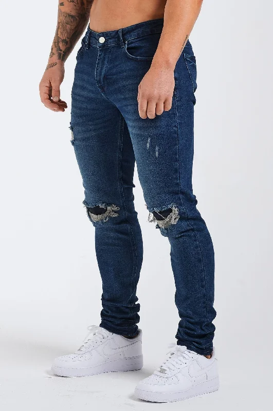 Men's Jeans with a Zip - Off Lower Leg for Convertible StyleSLIM FIT JEANS 2.0 DISTRESSED AND PATCHED - DARK BLUE